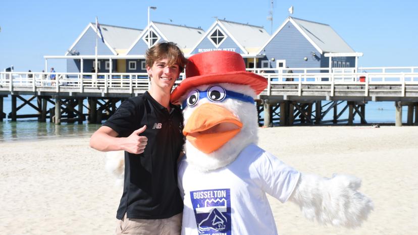 Finn Wright, Recipient Of South West Academy Of Sport Individual Athlete Support Program Scholarship, Sponsored By Busselton Jetty Swim, With Busselton Jetty Swim Mascot, Simon The Seagull, In Front Of Busselton Jetty Credit: Teneille Watson